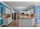 Modern kitchen featuring white cabinets, granite countertops, stainless appliances, and a spacious island at 340 Chandler Ct, Sugar Hill, GA 30518