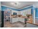 Open concept kitchen featuring white cabinets, granite countertops, stainless appliances, and wood floors at 340 Chandler Ct, Sugar Hill, GA 30518