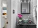 Powder room features a glass vessel sink on a black vanity with a modern mirror at 340 Chandler Ct, Sugar Hill, GA 30518
