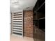 Walk-in closet with custom shelving and storage solutions; features exposed brick wall at 434 Marietta Nw St # 301, Atlanta, GA 30313