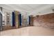 Spacious room with exposed brick, concrete pillars, and large windows with stunning cityscape views at 434 Marietta Nw St # 301, Atlanta, GA 30313