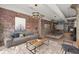 Inviting living room with exposed brick, modern furniture, and artistic decor, creating a stylish space at 434 Marietta Nw St # 301, Atlanta, GA 30313
