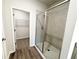 Glass enclosed tiled shower with access to a walk-in closet in the Primary bathroom at 5295 Greenway Dr, Villa Rica, GA 30180