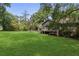 Expansive backyard featuring lush greenery, mature trees, and wooden porch at 6 Water View Dr, Stockbridge, GA 30281