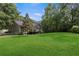 Spacious backyard with a well maintained lawn and mature trees at 6 Water View Dr, Stockbridge, GA 30281