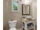 Bathroom with framed mirror, white bowl sink, granite countertop, and view to the yard at 6 Water View Dr, Stockbridge, GA 30281