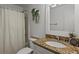 Bathroom featuring a granite vanity, shower-tub combo, and decorative plants at 6 Water View Dr, Stockbridge, GA 30281