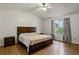 Cozy bedroom with ceiling fan, hardwood floors, and natural light from a large window at 6 Water View Dr, Stockbridge, GA 30281