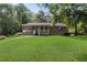 Charming home with a welcoming front porch and a well-maintained lawn and beautiful tree coverage at 6 Water View Dr, Stockbridge, GA 30281