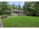 Inviting home featuring a classic front porch, lush green lawn and mature shady trees at 6 Water View Dr, Stockbridge, GA 30281