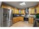 Well-appointed kitchen with stainless steel appliances, wood cabinets, and a tile backsplash at 6 Water View Dr, Stockbridge, GA 30281