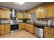 Functional kitchen with wood cabinets, stainless steel appliances, and practical layout at 6 Water View Dr, Stockbridge, GA 30281