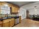 Well-lit kitchen features wood cabinets, granite countertops, stainless steel appliances, and dining area at 6 Water View Dr, Stockbridge, GA 30281