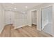 Second floor hallway with wood floors and access to a laundry room and bedroom at 113 Priestwood Ln, Acworth, GA 30102