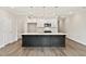 Modern kitchen with a large island, white cabinets, stainless appliances and wood flooring at 113 Priestwood Ln, Acworth, GA 30102