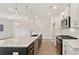 Open kitchen with island, stainless appliances and modern light fixtures at 113 Priestwood Ln, Acworth, GA 30102