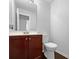 Half bath with hardwood vanity, framed mirror, and modern toilet at 2397 Charleston Ter, Decatur, GA 30034