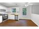 Well-lit kitchen with stainless steel appliances, white cabinets, and a window for natural light at 2397 Charleston Ter, Decatur, GA 30034