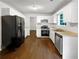 Modern kitchen with white cabinets, updated appliances, and luxury vinyl flooring at 2397 Charleston Ter, Decatur, GA 30034