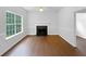 Bright living room with a decorative fireplace, large window and hardwood floors, perfect for relaxation at 2397 Charleston Ter, Decatur, GA 30034