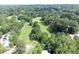 Stunning aerial view of lush green property featuring a golf course and an abundance of mature trees at 30 Chaumont Nw Sq, Atlanta, GA 30327