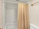 Bathroom with shower tub combination with a tan shower curtain at 30 Chaumont Nw Sq, Atlanta, GA 30327