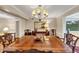 Traditional dining room boasts an elegant chandelier and a large wood table, perfect for Gathering gatherings at 30 Chaumont Nw Sq, Atlanta, GA 30327