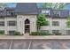 Charming condo building with black roof, neutral siding, brick accents, and well-manicured landscaping at 30 Chaumont Nw Sq, Atlanta, GA 30327