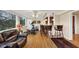 Bright living room with a view of the backyard, hardwood floors, and an open bar area with counter seating at 30 Chaumont Nw Sq, Atlanta, GA 30327