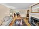 Bright living room flows into the dining area, featuring hardwood floors and fireplace at 30 Chaumont Nw Sq, Atlanta, GA 30327