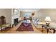 Bright living room featuring a fireplace, hardwood flooring, and comfortable seating arrangement at 30 Chaumont Nw Sq, Atlanta, GA 30327