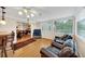 Comfortable living room with hardwood floors, leather seating, and large windows, perfect for relaxing and entertaining at 30 Chaumont Nw Sq, Atlanta, GA 30327