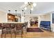 Open bar area with counter seating that connects the living room and kitchen, with hardwood floors at 30 Chaumont Nw Sq, Atlanta, GA 30327