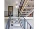 Stairwell leading up to unit showcasing neutral carpet, black metal handrails, and natural light at 30 Chaumont Nw Sq, Atlanta, GA 30327