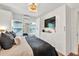 Bright bedroom featuring large closets, flat screen tv, and comfortable bedding at 575 E Main St, Buford, GA 30518