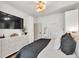 Cozy bedroom with built-in storage, large TV, and plush gray bedding at 575 E Main St, Buford, GA 30518