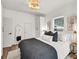 Comfortable bedroom with large window, modern lighting, and stylish decor at 575 E Main St, Buford, GA 30518