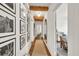 Hallway features hardwood floors, gallery wall, wooden beams, and arched mirror at 575 E Main St, Buford, GA 30518