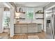 Bright kitchen features wood countertops, white stone backsplash, and modern stainless steel appliances at 575 E Main St, Buford, GA 30518