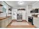 Kitchen featuring stainless steel appliances, floating shelves, and butcher block countertops at 575 E Main St, Buford, GA 30518