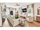 Bright living room featuring a white brick fireplace, a ceiling fan, and an oversized comfy couch at 575 E Main St, Buford, GA 30518