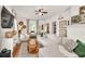 Bright living room featuring a white brick fireplace, a ceiling fan, and an oversized comfy couch at 575 E Main St, Buford, GA 30518