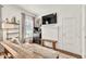 Cozy living room featuring a white brick fireplace, comfortable seating, and ample natural light at 575 E Main St, Buford, GA 30518
