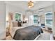 Bright main bedroom features stylish decor, closet, and lots of natural light from the two large windows at 575 E Main St, Buford, GA 30518