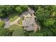 Aerial view of the estate showcasing the home's layout, circular driveway, and surrounding mature trees at 585 Old Cobblestone Dr, Atlanta, GA 30350