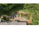 Aerial view showcasing the backyard, stone patio, and mature landscaping of the property at 585 Old Cobblestone Dr, Atlanta, GA 30350