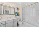 Bathroom featuring a single vanity, bathtub with glass doors, and tiled floor at 585 Old Cobblestone Dr, Atlanta, GA 30350
