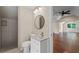 Bathroom with a vanity, round mirror, and tiled walk-in shower at 585 Old Cobblestone Dr, Atlanta, GA 30350