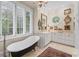 Bathroom with soaking tub, large windows, and natural light at 585 Old Cobblestone Dr, Atlanta, GA 30350