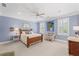 Bedroom with wood furniture, ceiling fan, and shuttered windows at 585 Old Cobblestone Dr, Atlanta, GA 30350